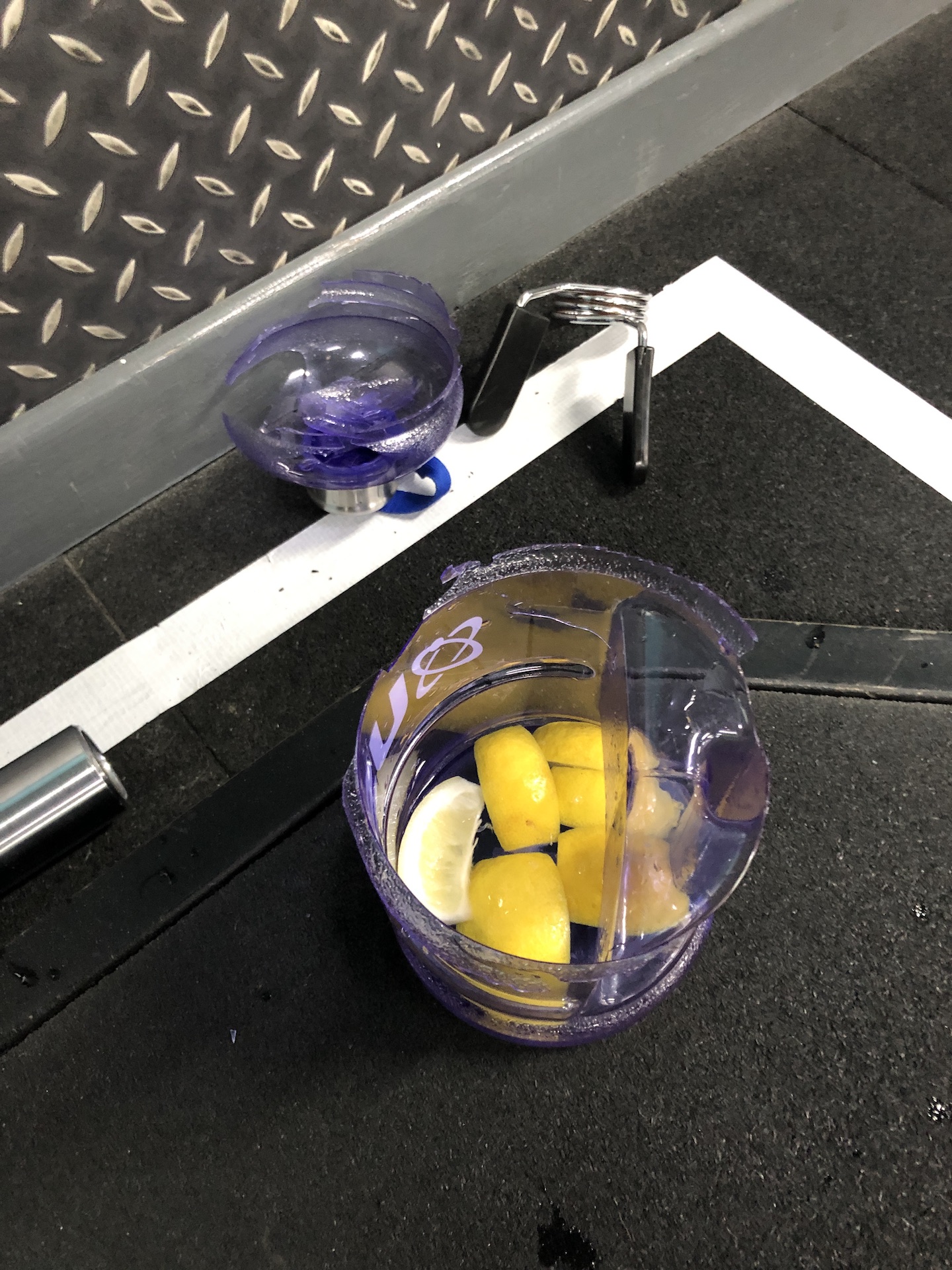 water bottle cut in half because a barbell fell on it